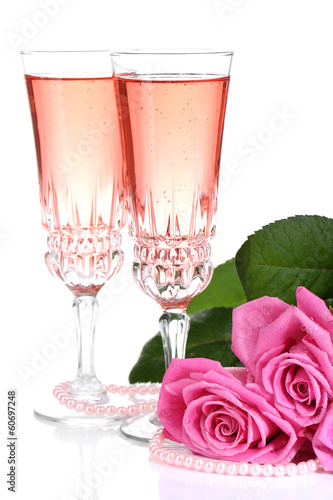 Photo: Composition with pink sparkle wine in glasses and pink roses Composition with pink sparkle wine in glasses and pink roses