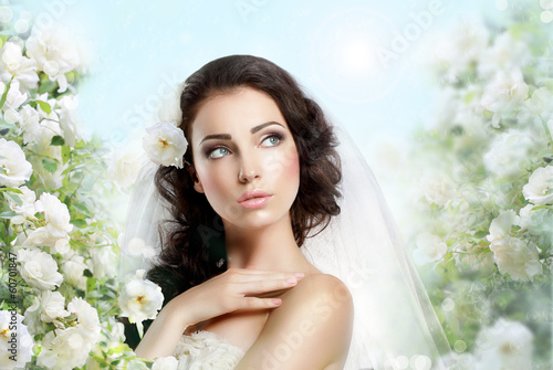 Photo: Exquisite Woman with Flowers over Vernal Floral Background Exquisite Woman with Flowers over Vernal Floral Background