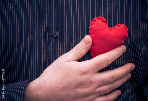 Photo: closeup red heart hand man closeup red heart hand man