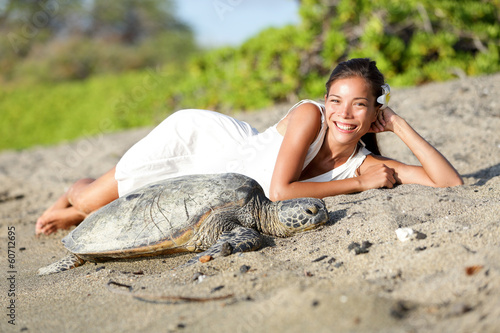 Photo: Turtle and woman lying on beach, Big Island Hawaii Turtle and woman lying on beach, Big Island Hawaii