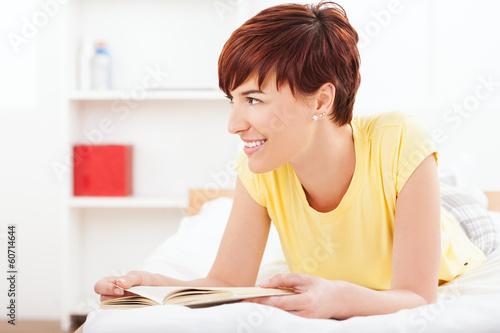 Photo: Young smiling women reading book Young smiling women reading book