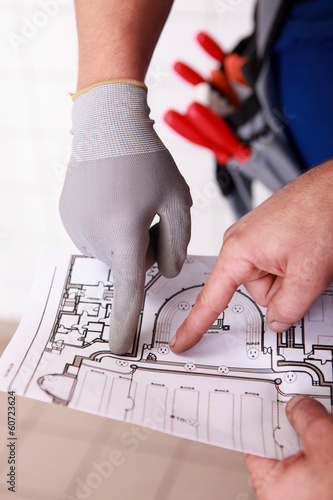 Photo: Workers pointing at building layout Workers pointing at building layout