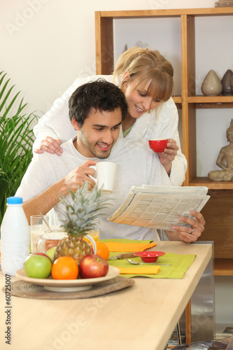 Photo: Couple at breakfast with a newspaper Couple at breakfast with a newspaper
