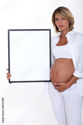 Photo: Pregnant women holding picture frame Pregnant women holding picture frame