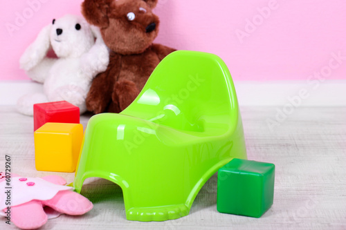 Photo: Green potty on home interior background Green potty on home interior background