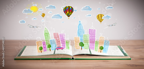 Photo: cityscape drawing on open book cityscape drawing on open book
