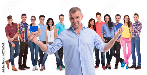 Photo: mature casual man welcoming to his young team mature casual man welcoming to his young team