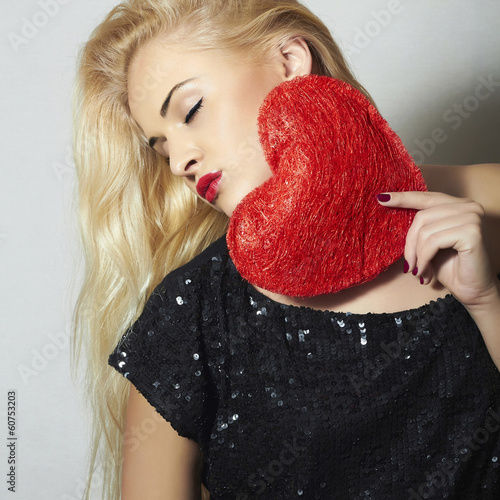 Photo: Beautiful Blond Woman with Red Heart.Love Symbol.Valentine's Day Beautiful Blond Woman with Red Heart.Love Symbol.Valentine's Day