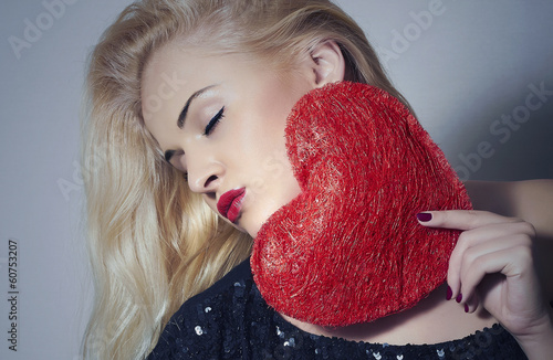 Photo: Beautiful Blond Woman with Red Heart.Love Symbol.Valentine's Day Beautiful Blond Woman with Red Heart.Love Symbol.Valentine's Day