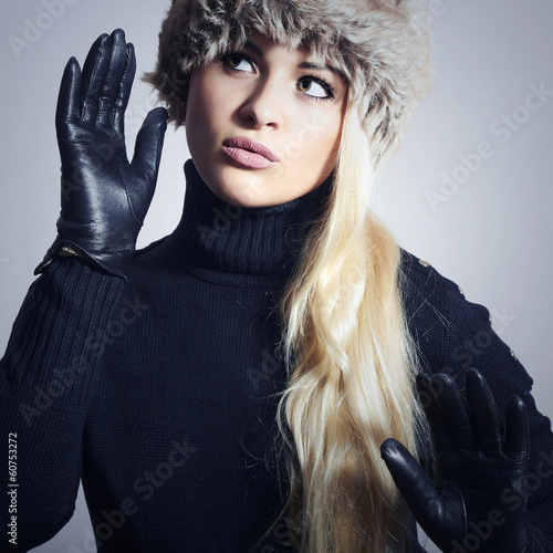 Photo: Girl in Fur Hat. Beautiful Blond Woman in Leather Gloves Girl in Fur Hat. Beautiful Blond Woman in Leather Gloves