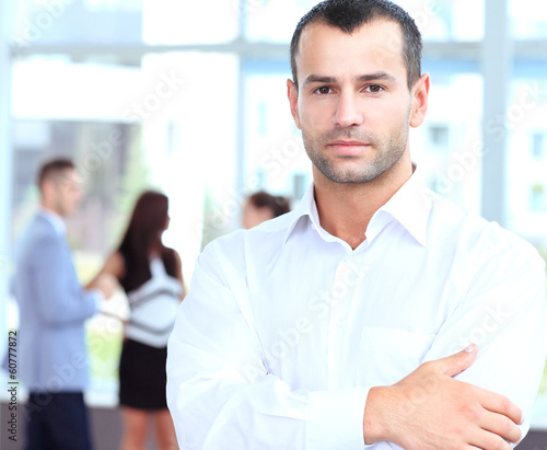 Photo: confident young businessman standing arms crossed, smiling happy confident young businessman standing arms crossed, smiling happy