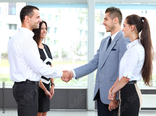 Photo: Business people shaking hands over a deal Business people shaking hands over a deal