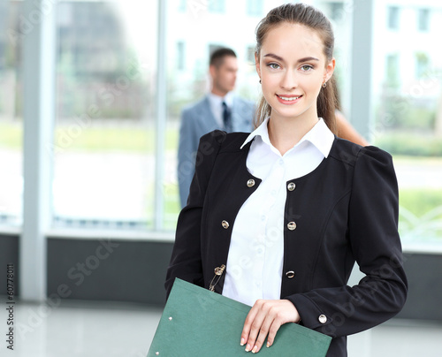 Photo: Face of beautiful woman on the background of business people Face of beautiful woman on the background of business people