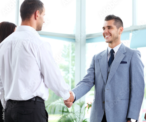 Photo: Business people shaking hands, finishing up a meeting Business people shaking hands, finishing up a meeting