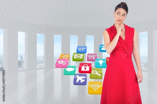 Photo: Composite image of thoughtful brunette in red dress posing Composite image of thoughtful brunette in red dress posing