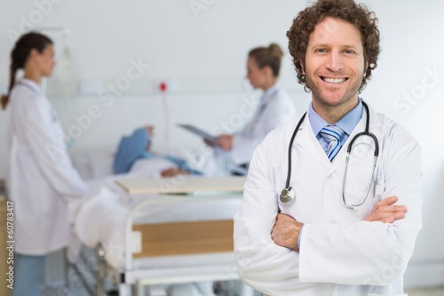Photo: Portrait of doctor standing arms crossed Portrait of doctor standing arms crossed