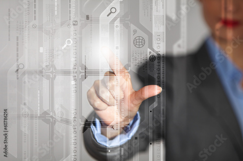 Photo: Businesswoman touching icon Businesswoman touching icon