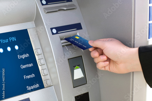 Photo: men hand businessman puts credit card into ATM men hand businessman puts credit card into ATM