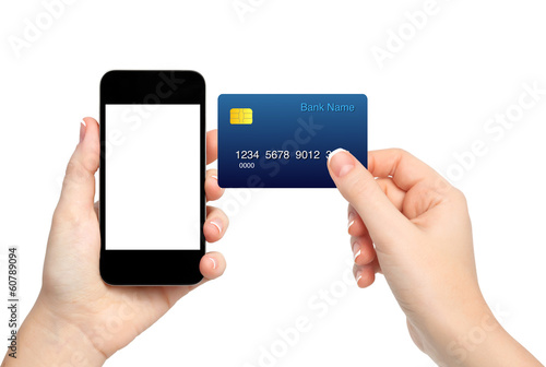 Photo: female hands holding phone and credit card on isolated backgroun female hands holding phone and credit card on isolated backgroun