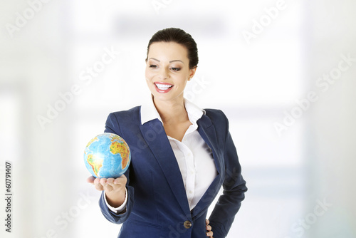 Photo: Young beautiful businesswoman holding the globe Young beautiful businesswoman holding the globe
