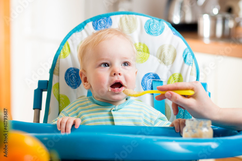 Photo: Mother feeding her cute baby boy Mother feeding her cute baby boy