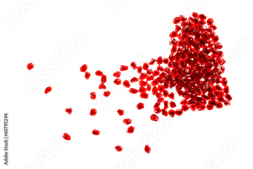 Photo: Red broken heart made of pomegranate seeds on white background Red broken heart made of pomegranate seeds on white background