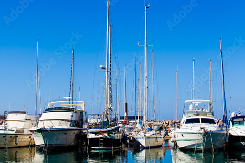 Photo: Yachts and boats anchored at a marina. Sailing Boats Yachts and boats anchored at a marina. Sailing Boats