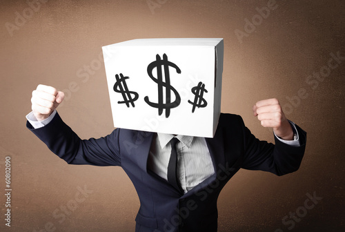 Photo: Businessman gesturing with a cardboard box on his head with doll Businessman gesturing with a cardboard box on his head with doll