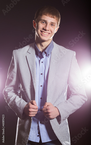 Photo: Young Happy Man Over a Black Background Young Happy Man Over a Black Background
