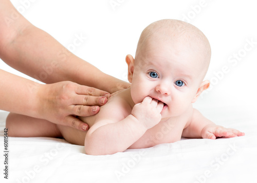 Photo: mother massaging her baby girl mother massaging her baby girl