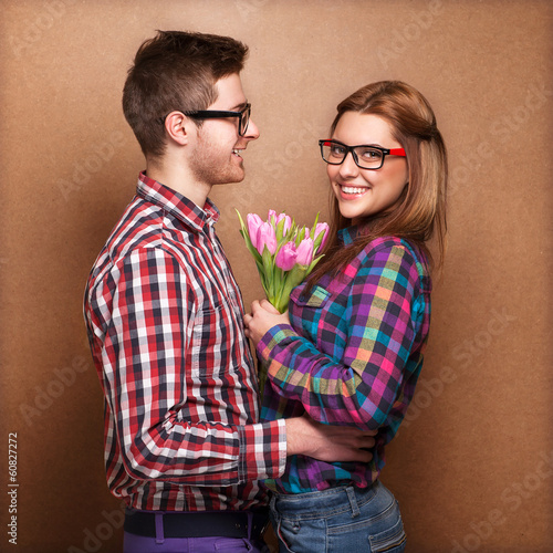 Photo: Beautiful young couple hug each other, the girl holding bouquet Beautiful young couple hug each other, the girl holding bouquet