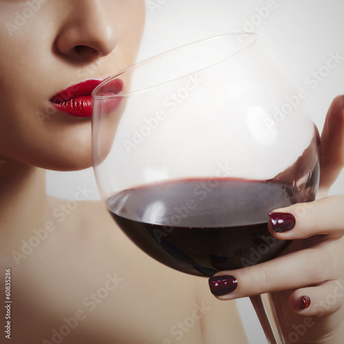 Photo: Woman Drinking Red Wine.Red Lips.Tasty Dry Wine.Manicure Woman Drinking Red Wine.Red Lips.Tasty Dry Wine.Manicure