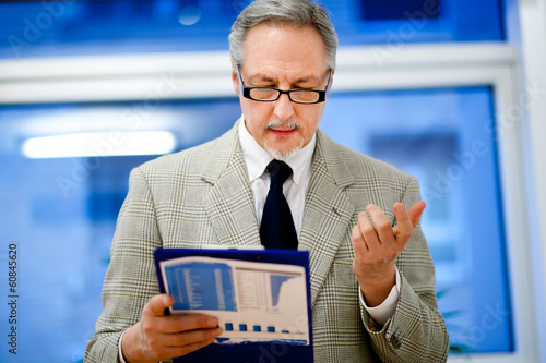 Photo: Businessman reading some documents Businessman reading some documents