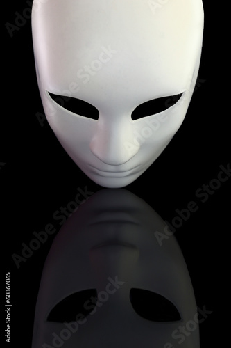 Photo: White mask with reflection on black background White mask with reflection on black background