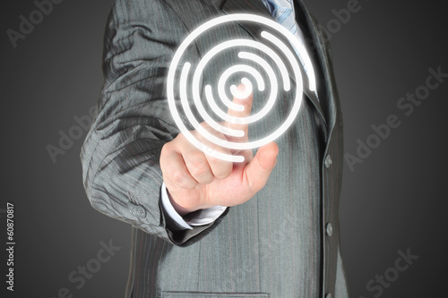 Photo: Man pushes icon on dark background Man pushes icon on dark background