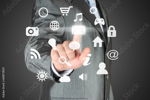 Photo: Man pushes icon on dark background Man pushes icon on dark background