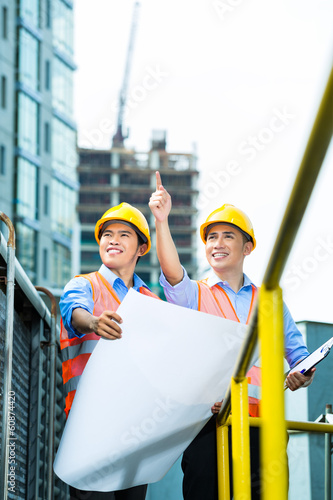 Photo: Asian Indonesian construction workers on building site Asian Indonesian construction workers on building site