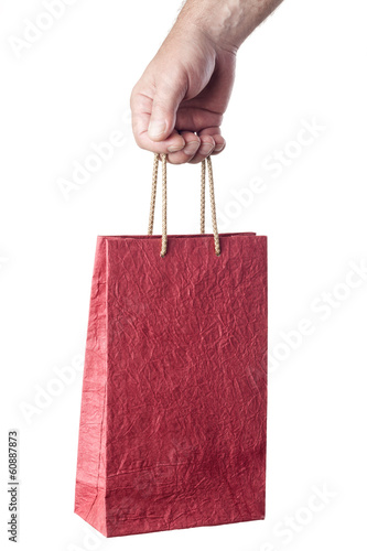 Photo: male hand holding red shopping bag isolated on white background male hand holding red shopping bag isolated on white background