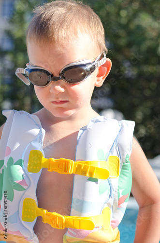 Photo: Little boy in swimming goggles on a hot summer day Little boy in swimming goggles on a hot summer day
