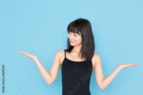 Photo: attractive asian woman on blue background attractive asian woman on blue background