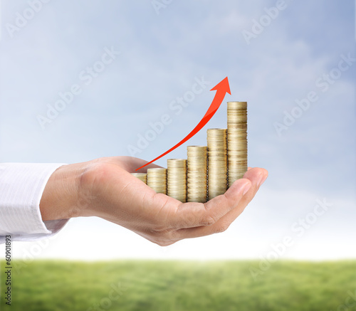 Photo: Hand put coin to money Hand put coin to money