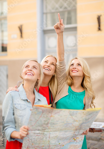 Photo: beautiful blonde women with map in the city beautiful blonde women with map in the city