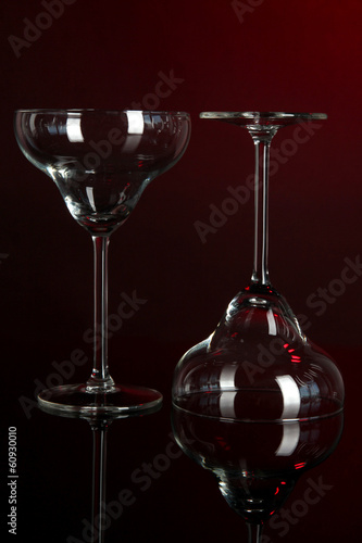 Photo: Two glasses on dark red background Two glasses on dark red background
