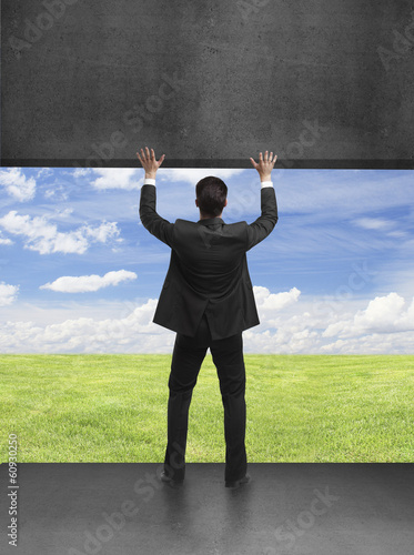 Photo: businessman holding wall businessman holding wall