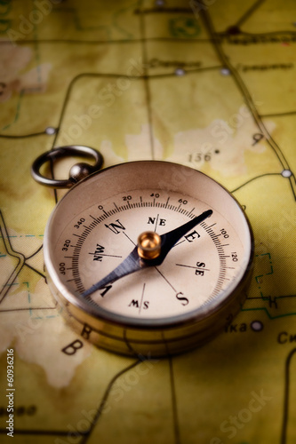 Photo: Compass lying on a map Compass lying on a map