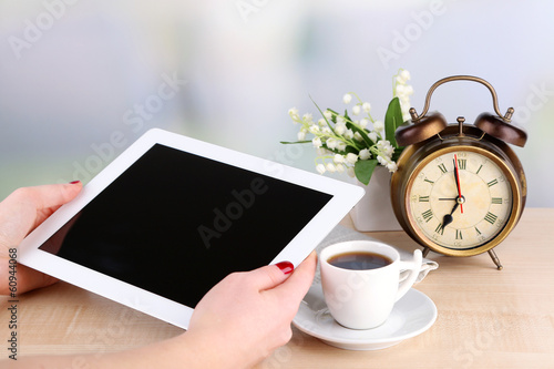 Photo: Tablet, cup of coffee and alarm clock, close up Tablet, cup of coffee and alarm clock, close up