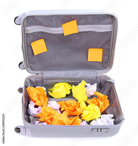 Photo: Open suitcase with paper stickers isolated on white Open suitcase with paper stickers isolated on white
