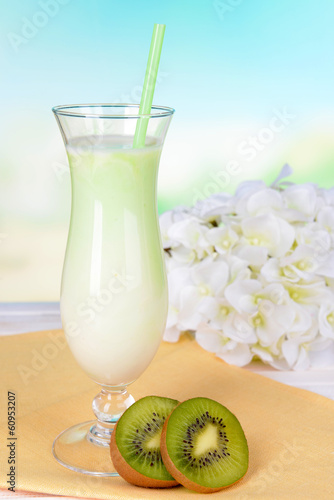 Photo: Milk shake on table on light blue background Milk shake on table on light blue background