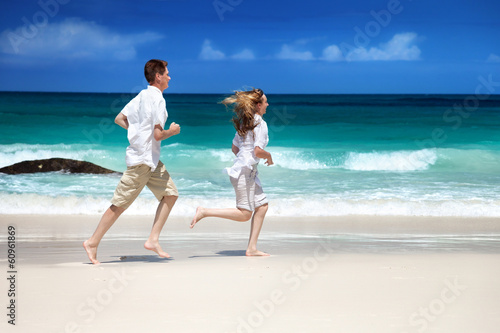 Photo: man and woman romantic couple on tropical beach man and woman romantic couple on tropical beach