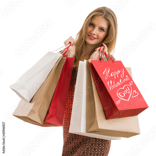 Photo: Shopping woman holding shopping bags looking at camera Shopping woman holding shopping bags looking at camera